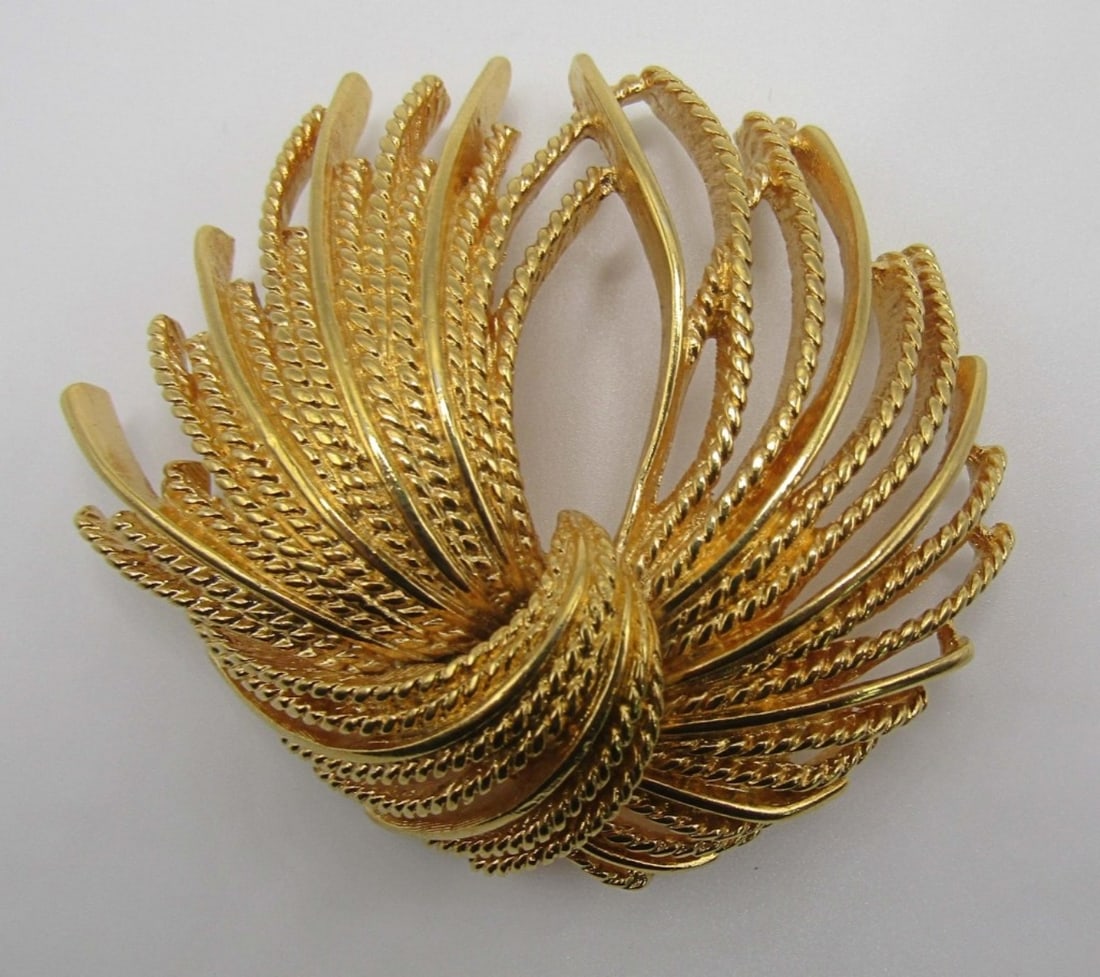 MONET BROOCH: GOLD TONE, STAMPED MONET,3IN IN LENGTH,