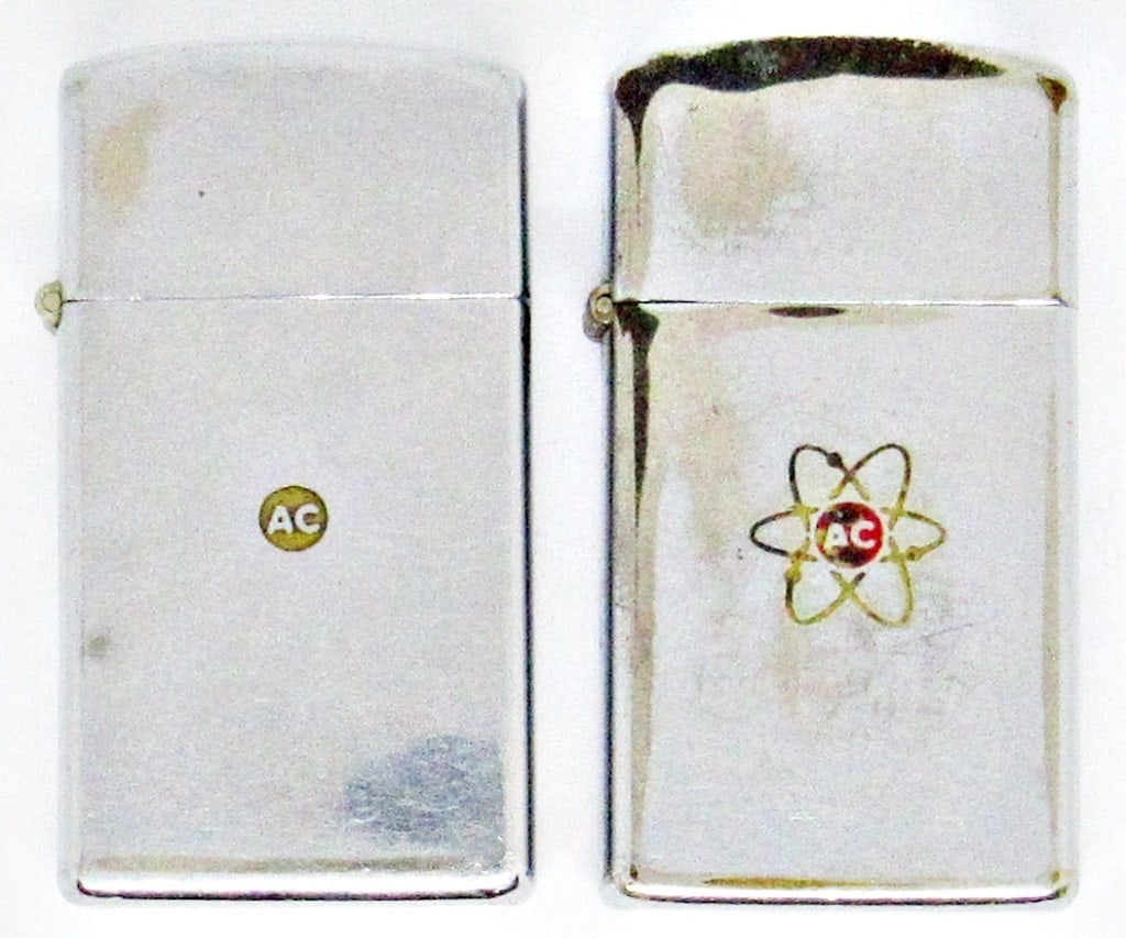 (2) VINTAGE 1960'S CHROME ZIPPO LIGHTERS: 1960'S SLIM STYLE, CHROME SILVER TONE ENGRAVED WITH AC ATOMIC LOGO; USED CONDITION