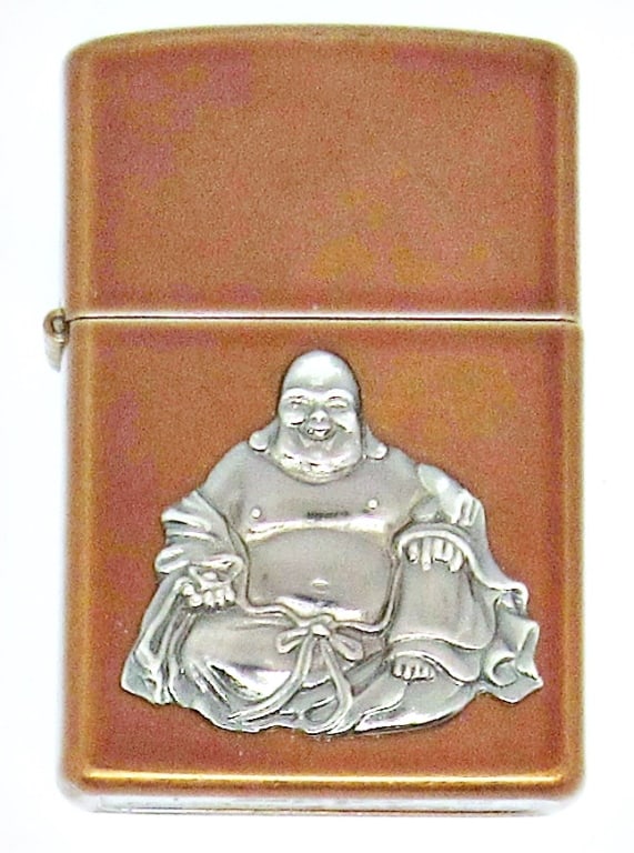2008 ORANGE GOLD TONE BUDDAH ZIPPO: 2008 ORANGE GOLD TONE ZIPPO WITH RAISED BUDDAH EMBLEM; USED CONDITION
