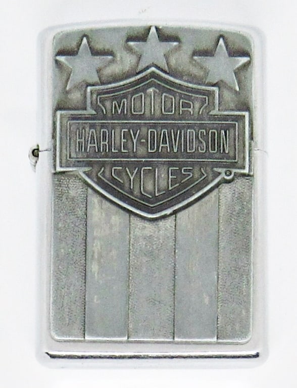 2004 HARLEY-DAVIDSON ZIPPO LIGHTER: 2004 HARLEY-DAVIDSON RAISED EMBLEM ZIPPO LIGHTER, SILVER TONE, ENGRAVED ON BACK; USED CONDITION
