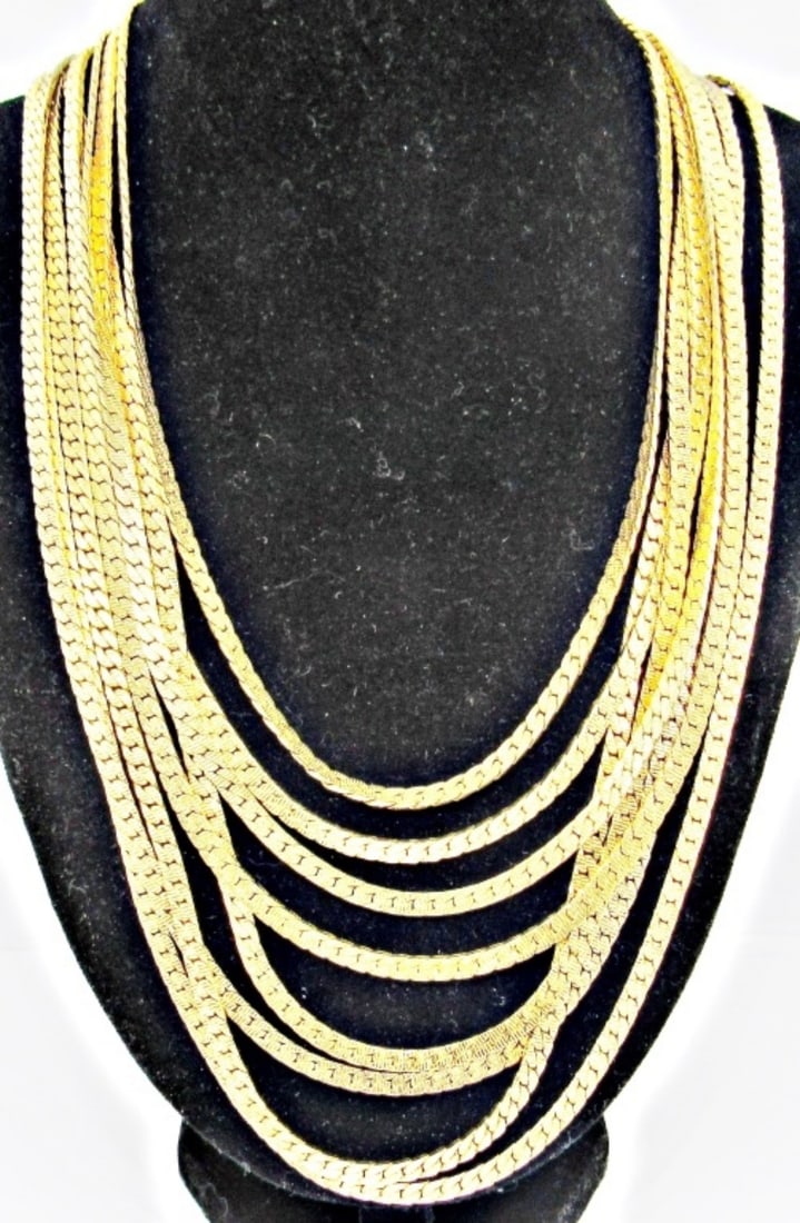 VINTAGE MONET LAYERED NECKLACE: 17IN LENGTH,8 LAYERS OF GOLDTONE SERPENTINE CHAIN, HOOK CLASP STAMPED BY MAKER, CAN BE ADJUSTED
