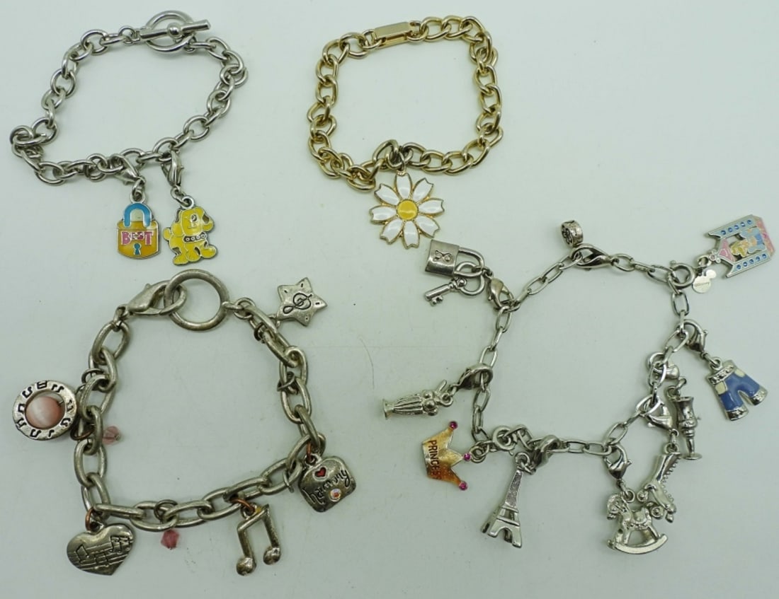 (4) CHARM BRACELETS: 1- SINGLE WHITE FLOWER CHARM; 1-MUSIC THEMED CHARMS; 1-"BEST" LOCK CHARM AND DOG CHARM; 1- 9 CHARMS SAKTE,CINDERELLA, CROWN TO NAME A FEW