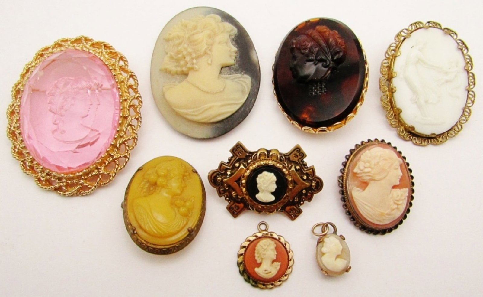 (9) Vintage Cameo Brooches & Pendants: Reverse Carved Pink Filigree Brooch, Porcelain Victorian Brooch, Hand Carved Shell (Pin Broke on Back), Victorian German Cameo Brown Topaz Amber Guilloche Brooch (Neck Broken Off), White on Black Orna