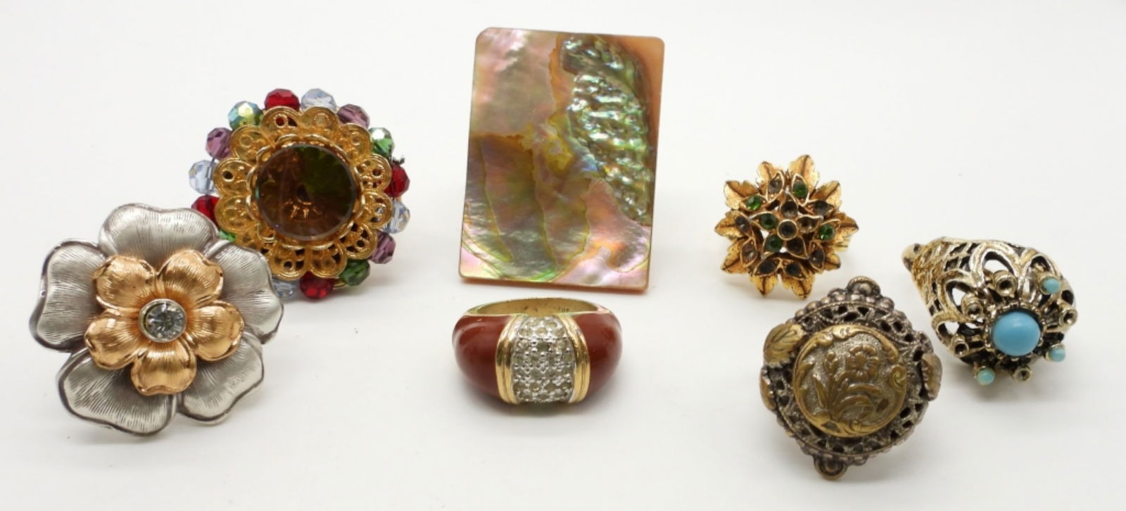 (7) UNQUIE FASHION RINGS (1) NAPIER: SIZES, 5-(2), 6-(3), 7-(2), 2 RINGS WILL NEED REPAIR MISSING TURQUOISE BEADING ON ONE AND GREEN STONES ON THE OTHER