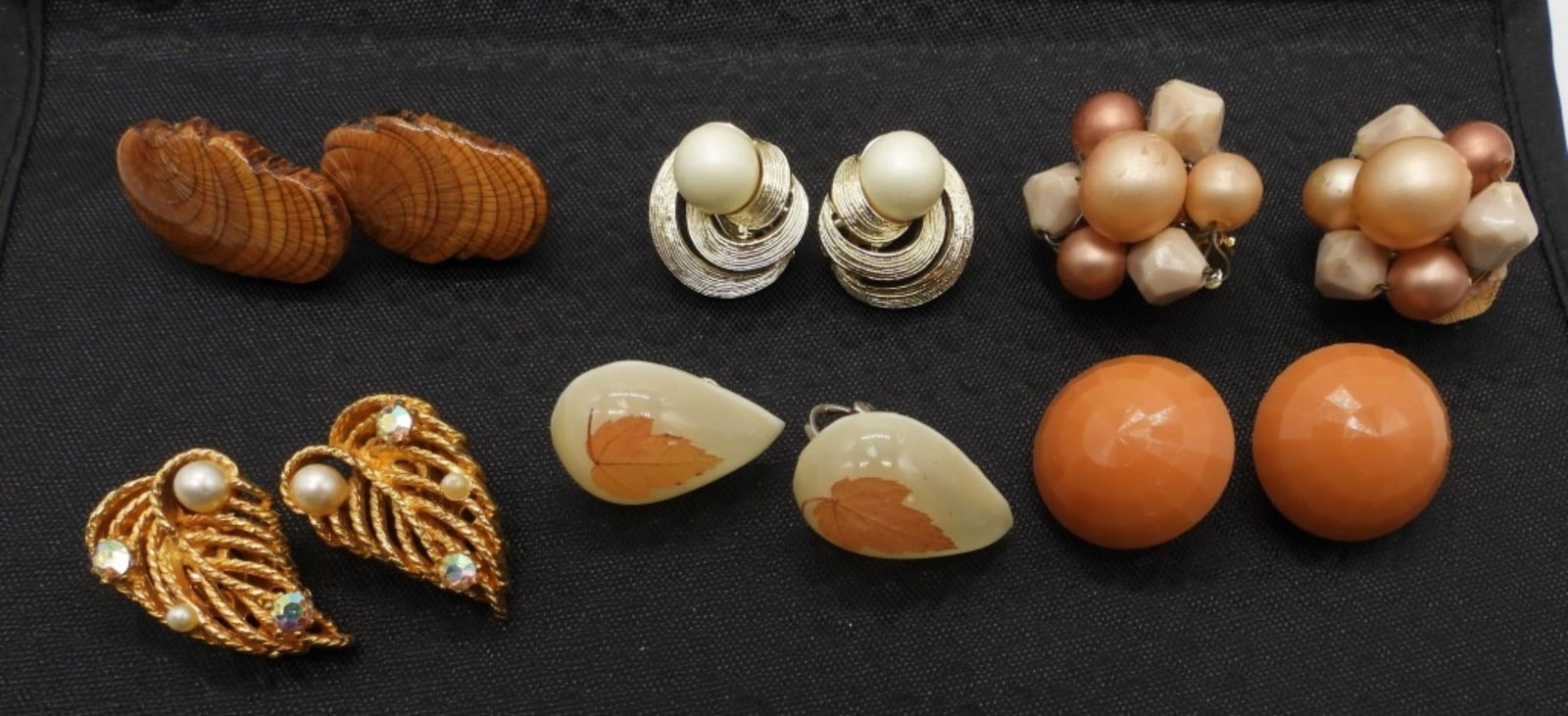 (6) CLIP-ON EARRINGS 1) WEST GERMANY (1) LISNER: 1 GOLD TONE W/ FAUX PEARL AND CLEAR STONES, 1- LEAF TEARDROP, 1 WOODEN SET, 1 GOLD TONE LISNER SET, 1 BLUSH AND CREAM BEADS SET, AND ONE ORANGE CIRCLE SET - (1) WEST GERMANY (1) LISNER