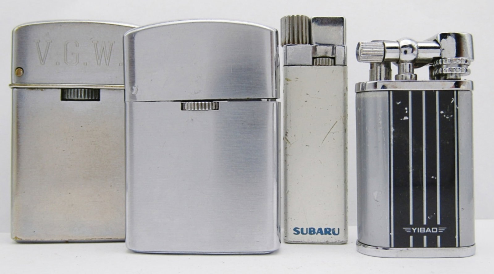 (4) Vintage Silver Toned Lighters: Sarome Gas (V.G.W. Engraved), Marathon Butane, Sonic Gas Guaranteed, Yibao; All used Conditions.