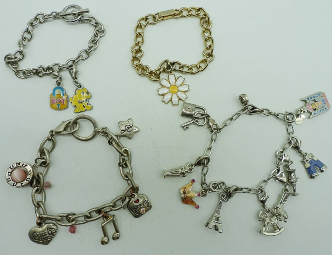 (4) CHARM BRACELETS: 1- SINGLE WHITE FLOWER CHARM; 1-MUSIC THEMED CHARMS; 1-"BEST" LOCK CHARM AND DOG CHARM; 1- 9 CHARMS SAKTE,CINDERELLA, CROWN TO NAME A FEW