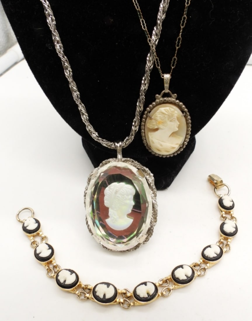 (2) CAMEO NECKLACE & (1) CAMEO BRACELET: 24IN LONG W/ CLEAR CAMEO PENDANT ON A SILVER CHAIN, SPRING CLASP, 20IN LONG W/ TAN CAMEO PENDANT ON A SILVER CHAIN SPRING CLASP, 8IN LONG GOLD TONE BLACK AND WHITE CAMEO W/ OPEN BOX CLASP