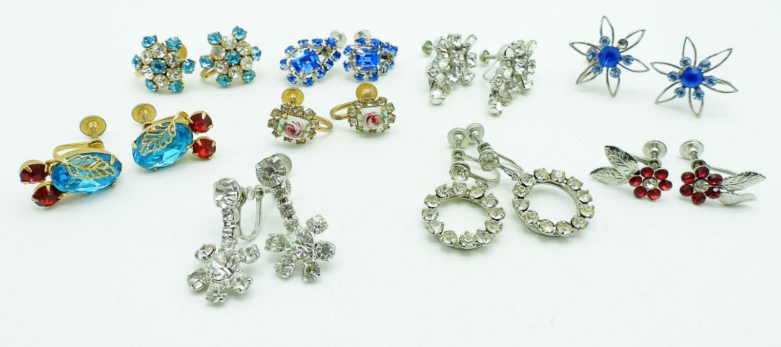 (9)VINTAGE SCREWBACK EARRINGS: 3 PAIRS OF CLEAR RHINESTONE SILVER TONE 2 PAIRS OF BLUE RHINESTONES SILVER TONE, 1 PAIR OF RED AND BLUE RHINESTONES GOLD TONE, 1 PAIR OF WHITE AND BLUE RHINESTONES GOLD TONE,1 PAIR OF RED RHINESTONE S