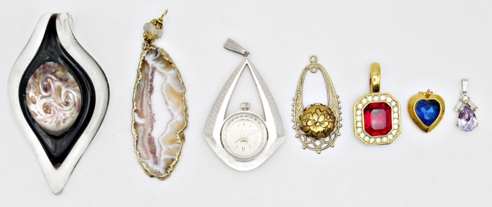 7 NECKLACE PENDANTS- DIFFERENT SHAPES AND: SIZES- ONE WITH WATCH FACE, RUBY/CRYSTAL STONES- SEE PICTURES
