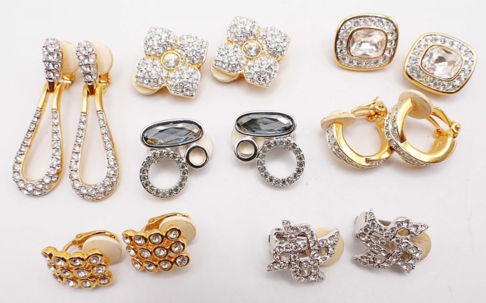 (7) SWAROVSKI CLIP-ON EARRINGS LOT: 2-SILVER TONE, 5- GOLD TONE PAIR, CLEAR STONES ON EACH PAIR, ALL DIFFERENT STYLES