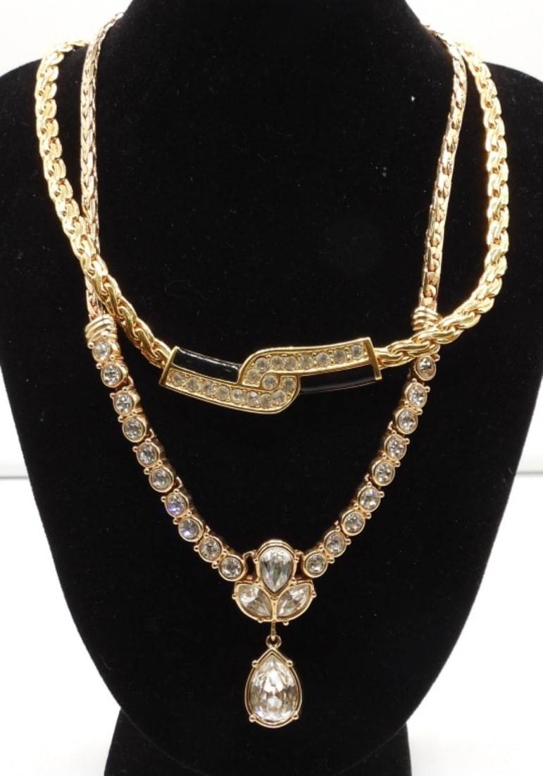 (2) FESTOON NECKLACES: GOLD TONE, 1- 16IN LONG WITH CLEAR STONES IN THE MIDDLE WITH A DROP PENDANT, OPEN BOX CLASP, 1- 17IN LONG, OPEN BOX CLASP, WITH CLEAR STONES AND BLACK ONYX INLAY IN THE MIDDLE