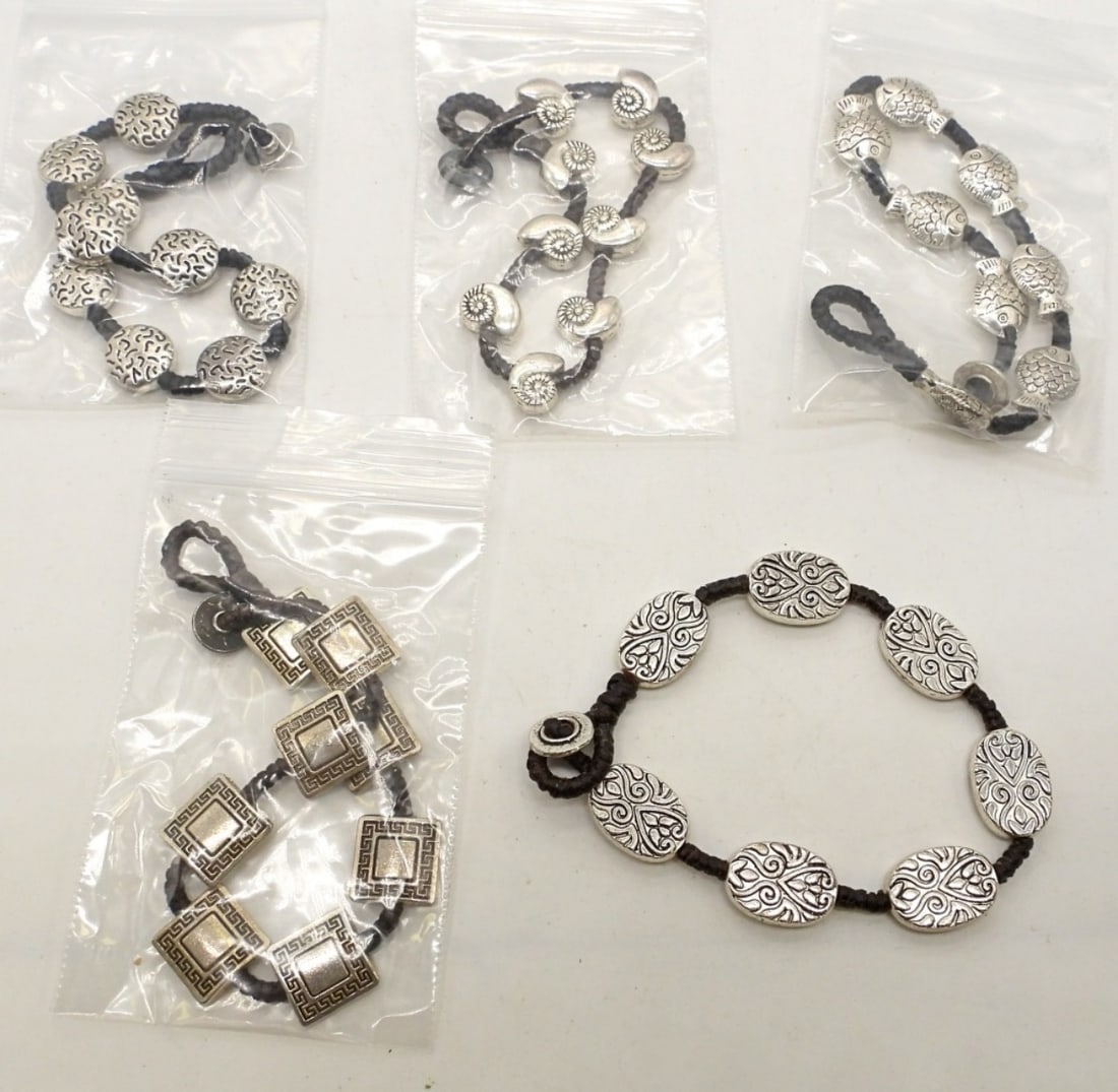 (5) CORDED AND SILVER BRACELET: 1- SEASHELL, 1- FISH, 1 SQUARE WITH DESIGN, 1 OVAL, 1 CIRCLE, W A TOGGLE CLASP