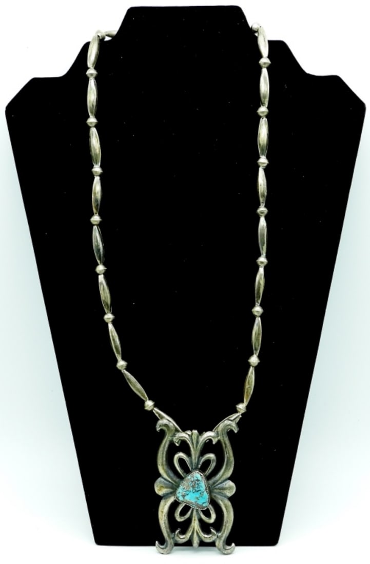 SOUTHWEST STERLING NECKLACE: 56DWT, 25IN LONG WITH HOOK CLASP, NO MARKINGS, PENDANT HAS A TURQUOISE STONE IN THE MIDDLE