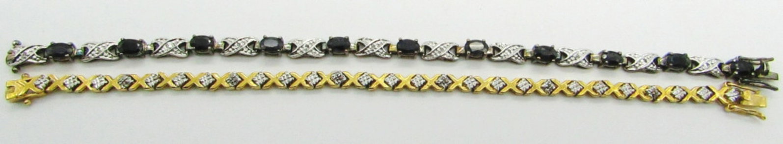 (2) Sterling Silver Bracelets: 14.6 dwt. Both Marked "925"; Blue Topaz Tennis Bracelet 7.5"; X Tennis Bracelet 7.5"