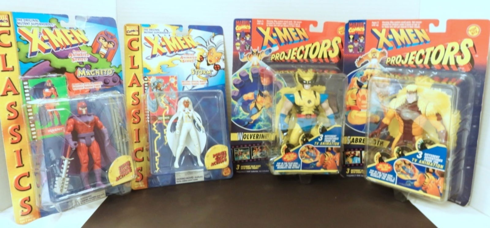 (4) MARVEL X-MEN ACTION FIGURES: (2) PROJECTORS WOLVERINE & SABRETOOTH (2) CLASSICS MAGNETO & STORM - ALL in SEALED BLISTER PACKS