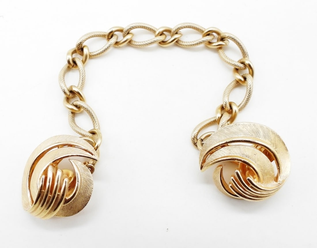 TRIFARI SWEATER CLIPS GOLD TONE SWIRLS: 4" CHAIN. SIGNED ON BACK OF EACH CLIP