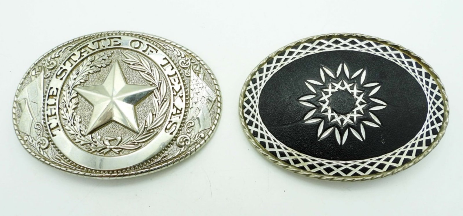 (2) MENS BELT BUCKLES: SILVER TONE NEAR 4IN WIDE, 1 STATE OF TEXAS WITH STAR IN THE MIDDLE, 1 BLACK INLAY WITH ETCHED SILVER TONE DESIGN