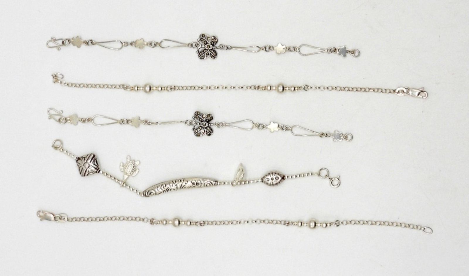 (5) STERLING SILVER BRACELETS MARKED 925: 6"-7" LENGTHS STERLING SILVER BRACELETS WITH MARCASITE, TURTLE, BUTTERFLY, FLOWER DESIGNS - 10 DWT - ALL MARKED 925