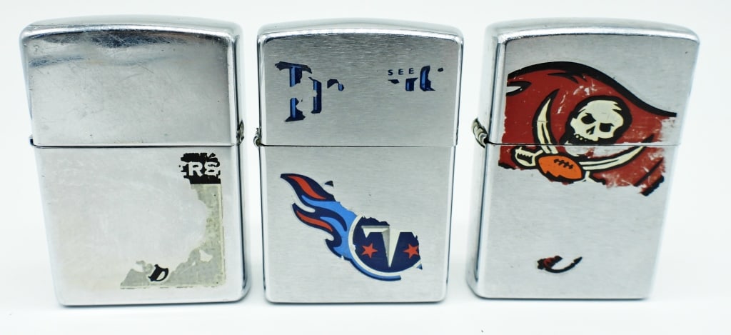 (3) NFL TEAM ZIPPO LIGHTERS: LOGOS FOR EACH TEAM ARE FADING, 1- TENNESSE TITIANS 2000, 1- RAIDERS 2007, 1- TAMP BAY 2000, ALL USED CONDITION