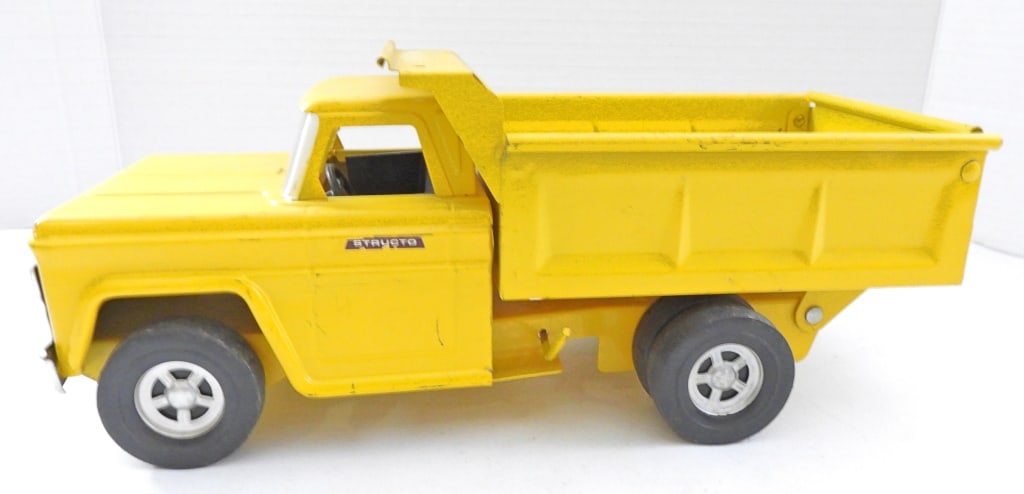 VINTAGE STRUCTO DUMP TRUCK: STAMPED ON THE BOTTOM -U.S. PAT. 3307291, CANADA PAT. 966, WHEELS WORK AND AND KNOB TO LIFT THE BACK STILL IS FUNCTIONAL