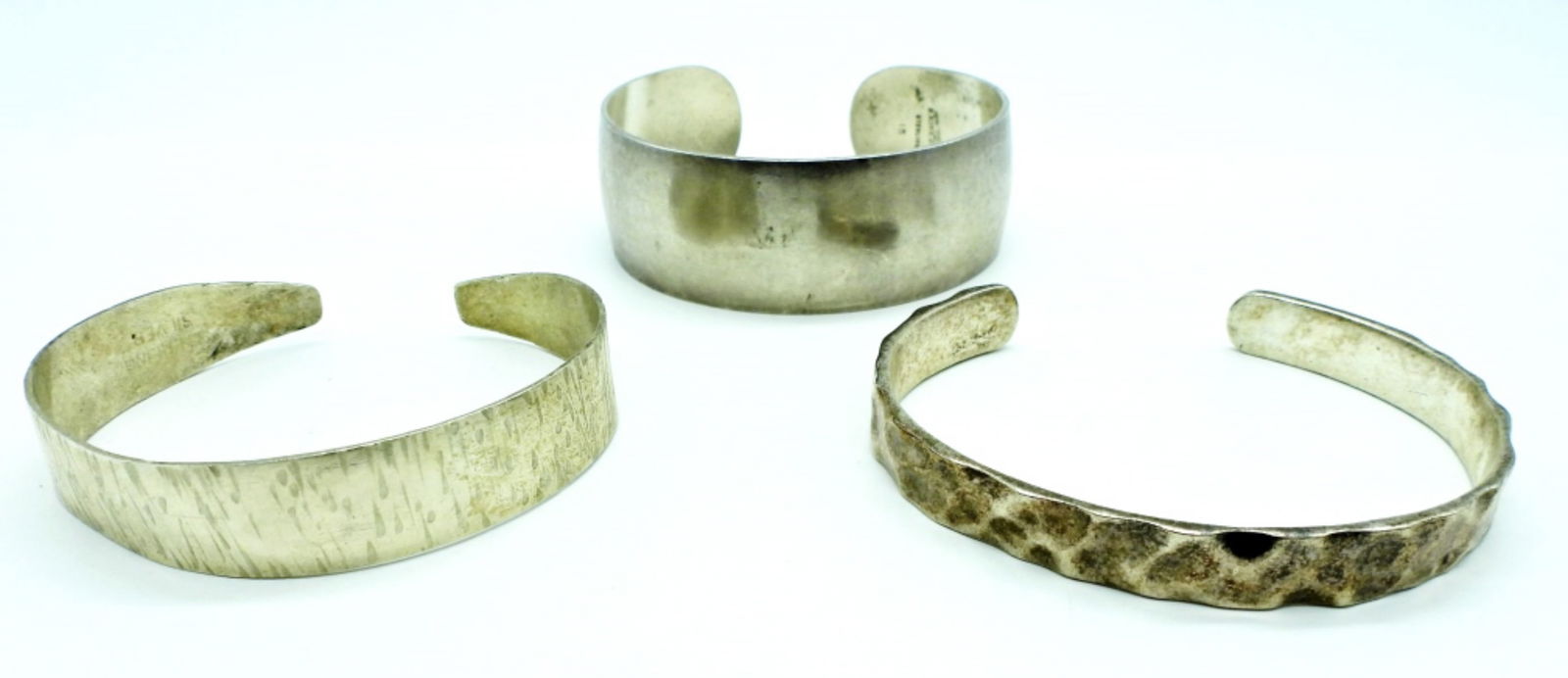 (3) STERLING CUFF BRACELETS: 52DWT, 2 1/2- 3IN WIDE, 1- STAMPED 925, 1- STAMPED STERLING SILVER, 1- STAMPED S. KIRK & SON STERLING 15
