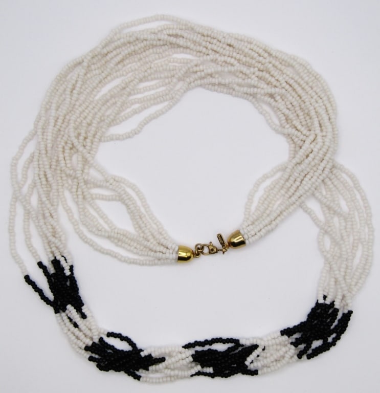 VINTAGE MONET LUCITE SEED BEAD NECKLACE: 29" BLACK & WHITE 8-STRAND NECKLACE. GOLD TONE END CAPS. SIGNED MONET ON LOBSTER CLAW AND HANGTAG.