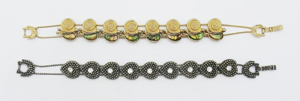 (2) WOMENS FASHION BRACELETS: 7 1/2IN LONG FOR BOTH, 1 GOLD TONE SNAIL WITH ABALONE INLAY, 1 SILVER TON HEART WITH CLEAR STONES IN THE MIDDLE OF EACH, OPEN BOX CLASP FOR BOTH,
