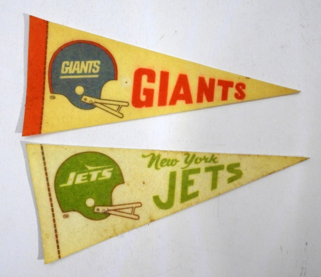 (2) VINTAGE MINI FOOTBALL PENNANTS JETS & GIANTS: 9" LONG 1- NEW YORK GIANTS, 1- NEW YORK JETS, DISCOLORED FROM THE YEARS, BOTH HAVE A HOLE FROM BEING PINNED UP
