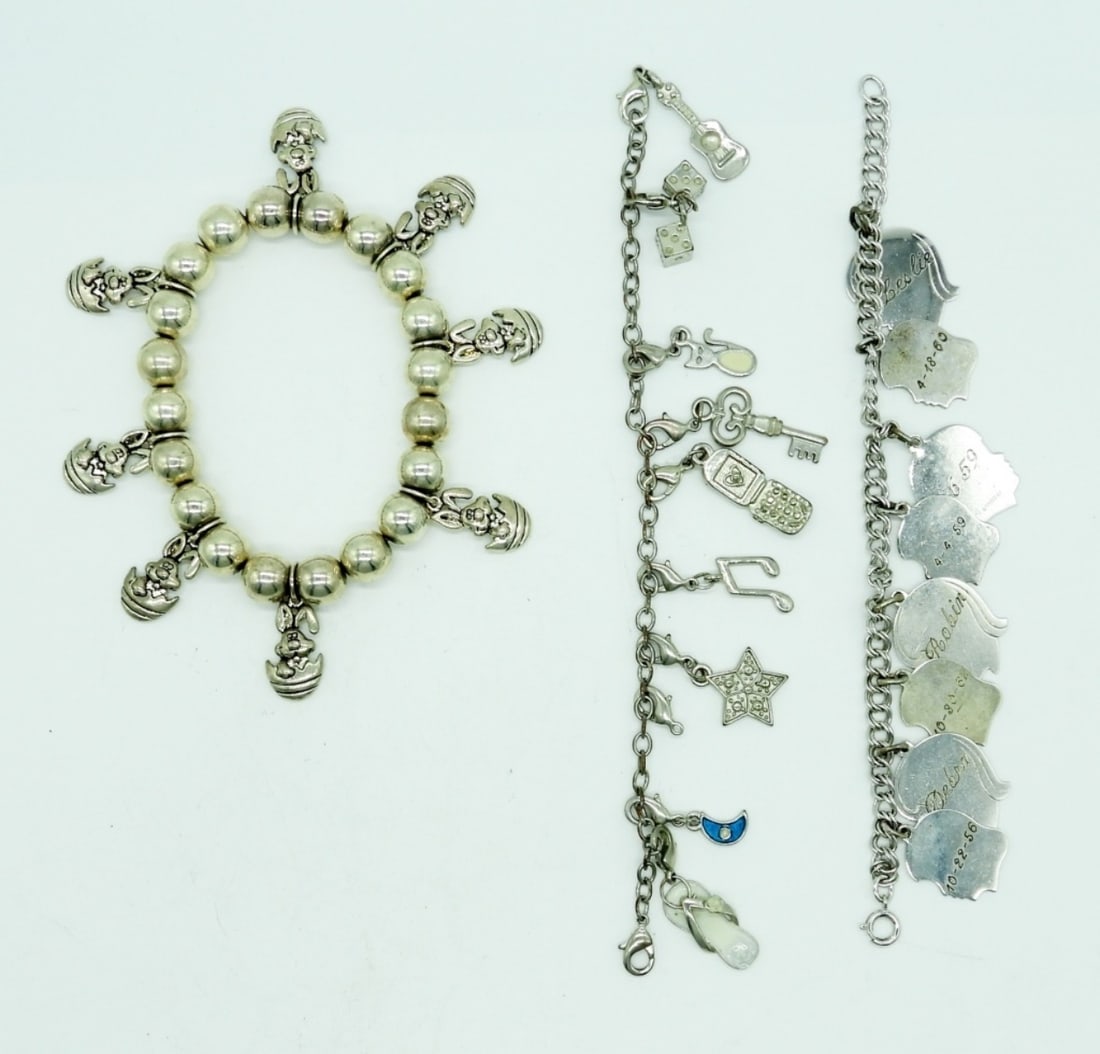 (3) SILVER TONE CHARM BRACELETS: (1) STRETCHY BRACELET WITH SILVER BEADS & EASTER BUNNY EGG CHARMS; (2) 7" CHAIN BRACELETS WITH DIFFERENT CHARMS, ENGRAVING