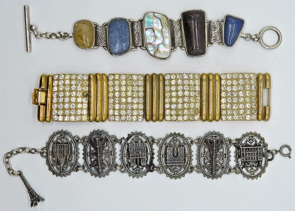Three Statement Bracelets: Gold and silver tone in various lengths, and styles.
