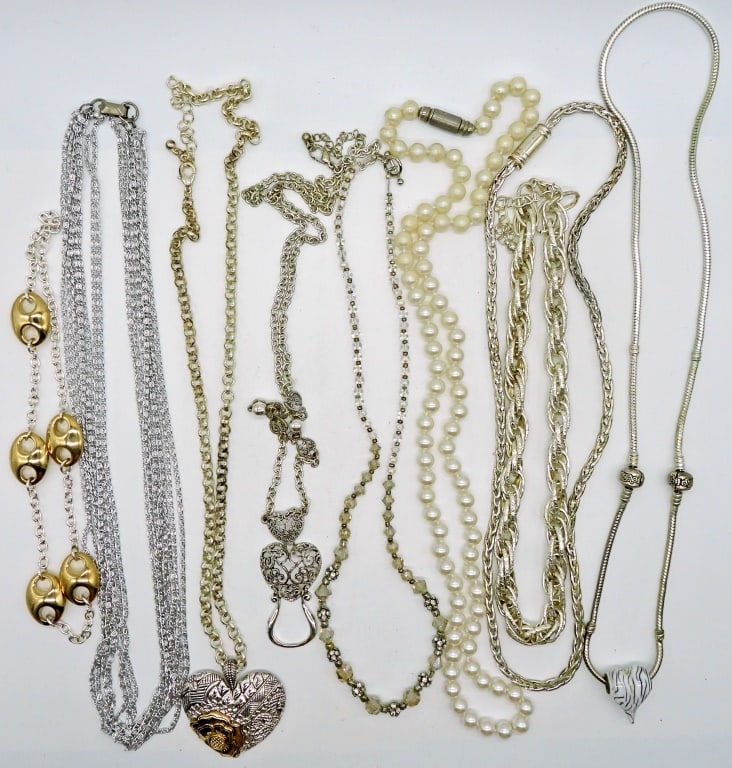 8 Silver Tone Fashion Necklaces: Silver tone, faux pearl, heart motif, and more. Various lengths short to long. This lot is very pretty!