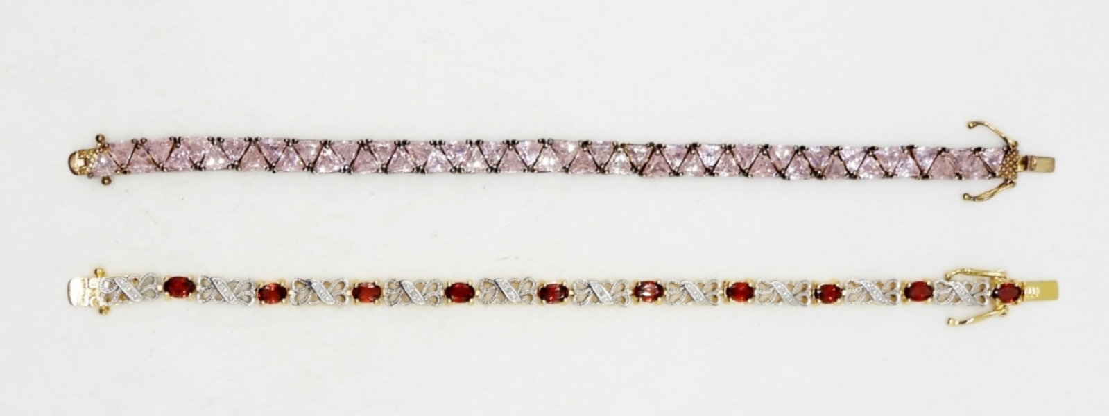 925 Gold Tone Tennis Bracelets: Two tennis bracelets, 7 inches each. One pink stone, one red stone. DWT 25.1