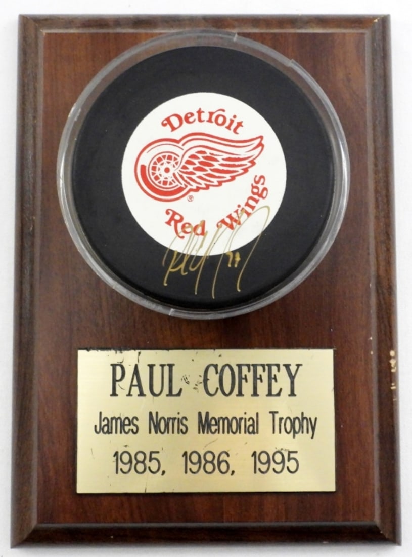 PAUL COFFEY AUTOGRAPH NHL RED WINGS PUCK W/COA: ON THE OFFICIAL LICENSED PRODUCT OF THE NHL RED WINGS, THIS PUCK IS ON A JAMES NORRIS MEMORIAL TROPHY 1985,1986,1995, COA STICKER ON THE BACK OF PLAQUE FROM MEMORY LANE