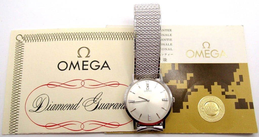 Omega 14KT and Diamond Dress Watch: Ref D6672, Perfect Original Silver Diamond Dial, 17 Jewel Cal 620 Movement, 32mm Diameter, 14KT White Gold Snapback Case. Fitted with a White Gold Filled Speidel Stretch Band. Complete with a Diamond