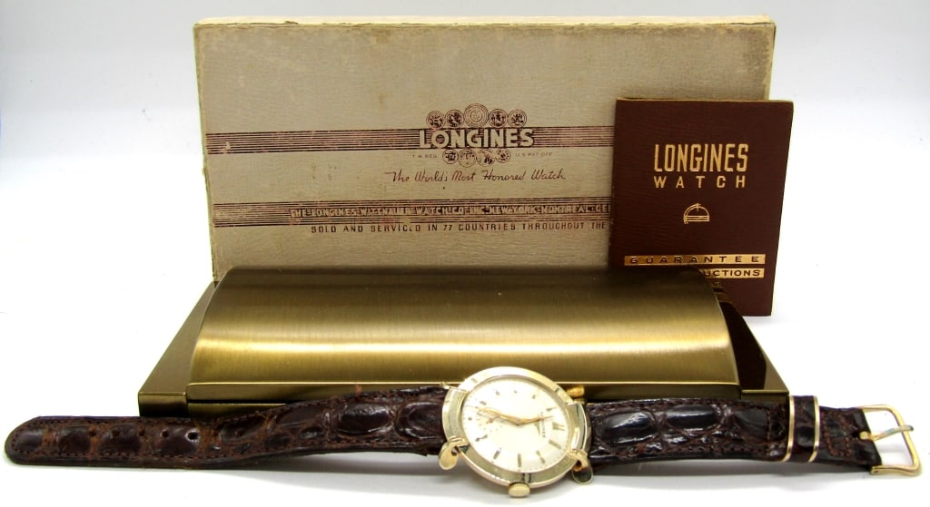 14KT Gold Longines - Deco: Wonderful Original and Mint Dial & Hands. Wonderful Styalized and Sculpted Lugs. 17 Jewel Cal 22L Movement, 33mm Case, With Original Strap and Buckle. Also included is the original box and warranty bo