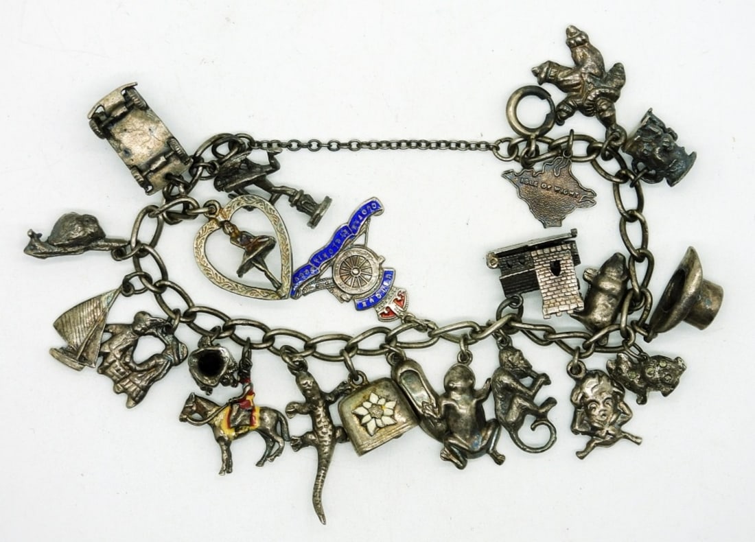 Sterling Vintage Charm Bracelet: Sterling Silver Charm Bracelet, 6-7 in length with 22 Sterling Silver Charms. 35DWT