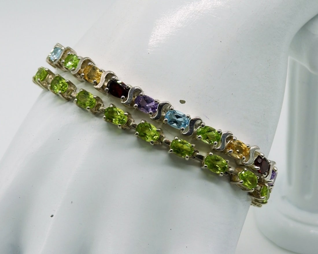 Two Sterling Gemstone Tennis Bracelets: Two 7 inch Sterling Bracelets, One with Peridot Colored Gemstones and One with Many Colored Gemstones. 18.5 DWT