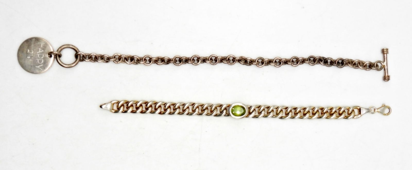 (2) STERLING SILVER CHAIN BRACELETS: 6.5 INCH STERLING SILVER CHAIN BRACELET WITH GREEN CENTER GEMSTONE - STAMPED 925; 8 INCH SILVER STERLING CHAIN BRACELET WITH ENGRAVED CIRCLE CHARM - STAMPED 925; 28.6 DWT