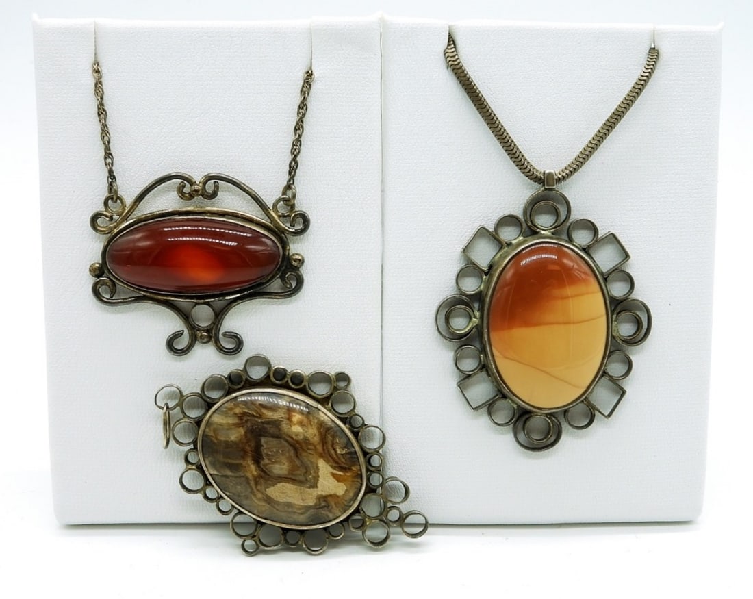 Vintage Sterling Handmade Pendants: Three beautifully handmade pendants in sterling silver settings. Brown Jasper Pendant Engraved with "Original Designed and Handmade by Marge Hughs 1977" Two have chains that measure 15 inches. (DWT 28