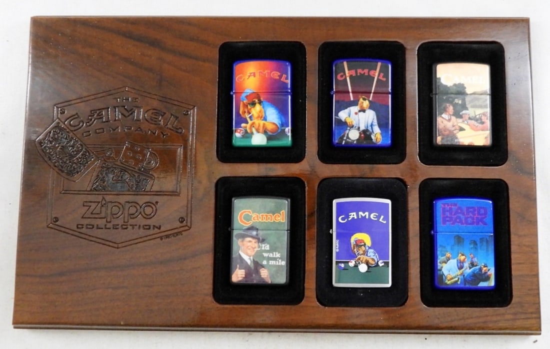 (6) THE CAMEL COMPANY ZIPPO COLLECTION PLAQUE: ALL FROM THE 90S, 5 OUT 6 ARE SEALED, OTHER IS UNFIRED, ALL IN A WOOD PLAGUE DISPLAY