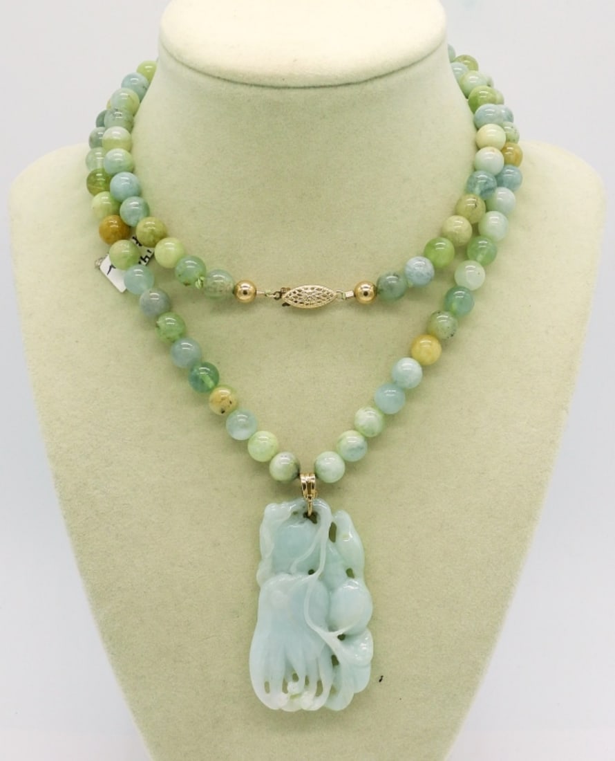 Jade & Aquamarine Beaded Necklace: Jade pendant on a 29" Beaded Necklace (Jade and Aquamarine). Clasp is 14K Yellow Gold.