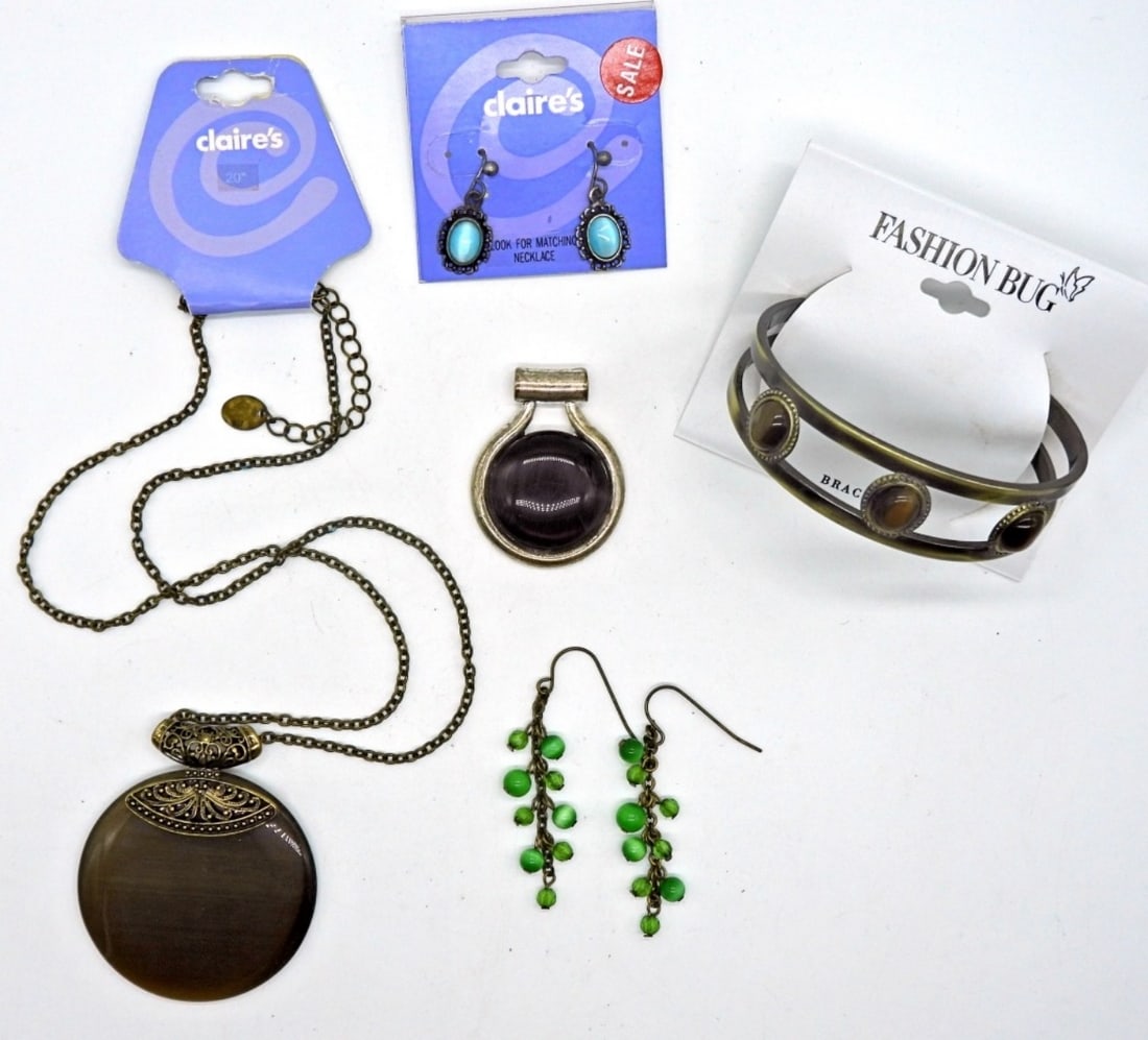 Cat's Eye Jewelry: Faux cat's eye. One 20 in necklace, one loose pendant, one cuff bracelets, and two pairs of earrings. Various colors.