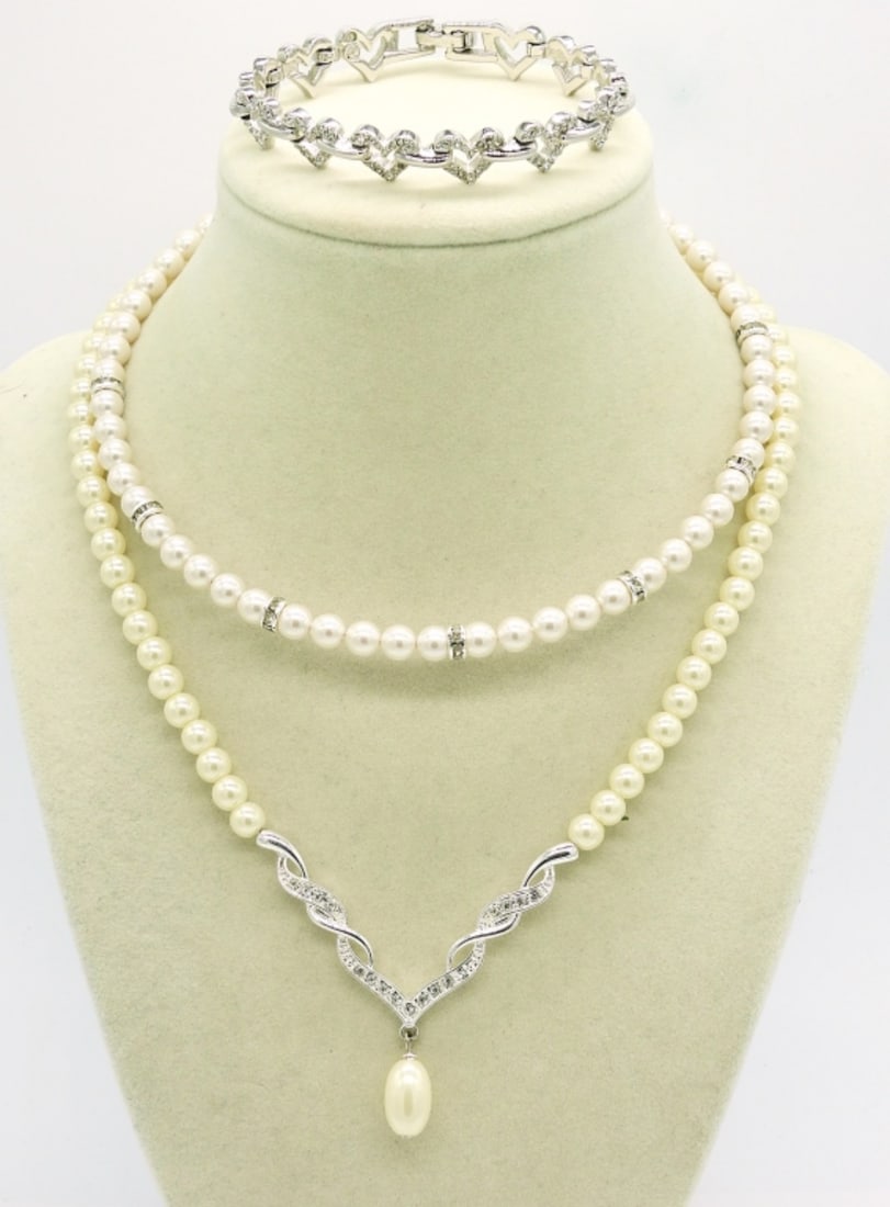 2 Faux Pearl Necklaces & a Bracelet: Two Silver tone faux pearl necklaces, 21", 14". Silver Tone Bracelet with Clear gemstones, 7".