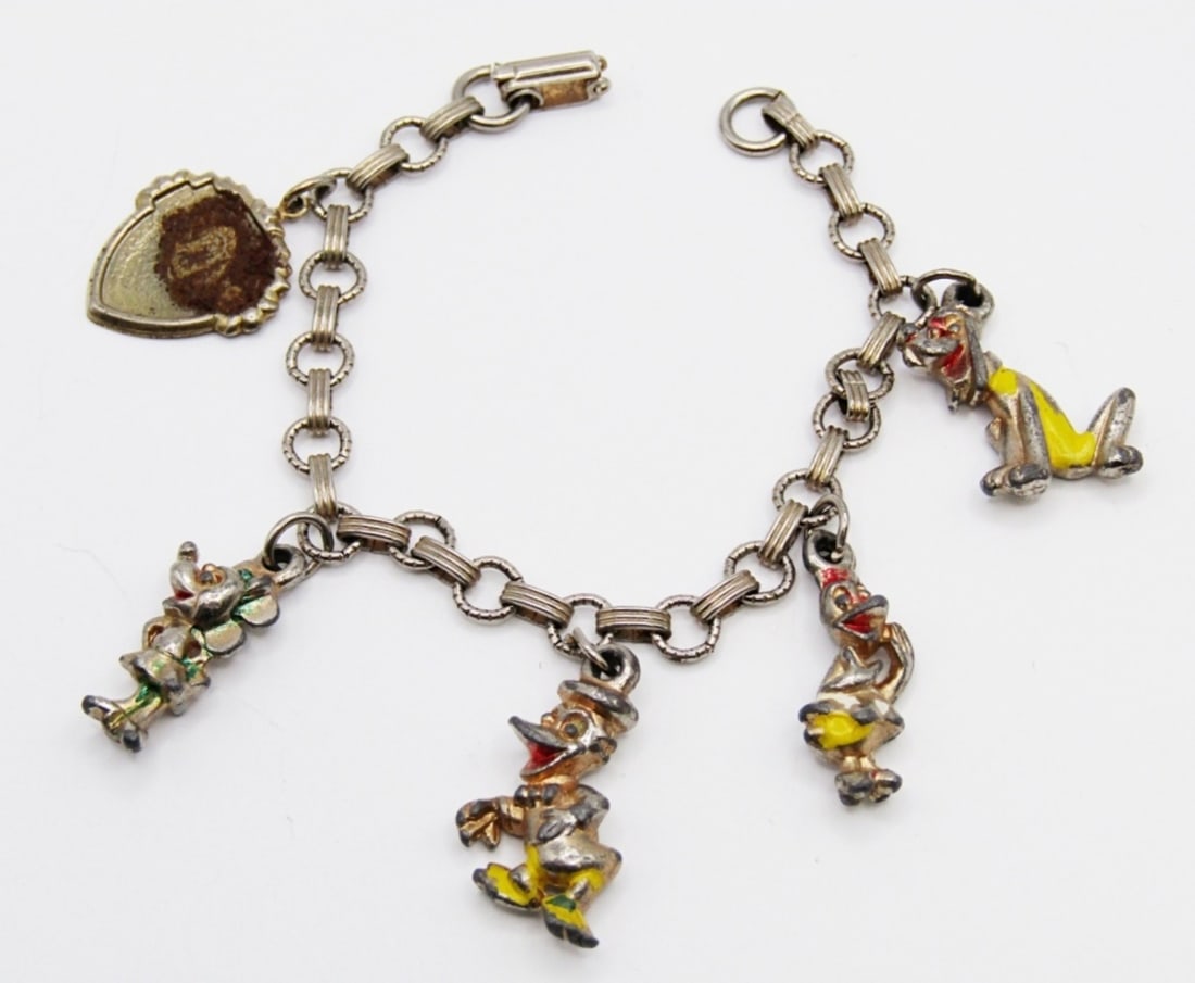 VINTAGE DISNEY CHARM BRACELET: 6.5" SILVER TONE BRACELET W/ (5) CHARMS: PLUTO, DONALD, DAISY, MINNIE, & SHIELD.