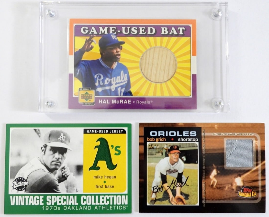 (3) 1970s GAME MEMORABILIA / GAME USED: UPPER DECK HAL McRAE GAME-USED BAT, UPPER DECK MIKE HEGAN GAME-USED JERSEY, TOPPS AMERICAN PIE BOB GRICH GAME-USED JERSEY