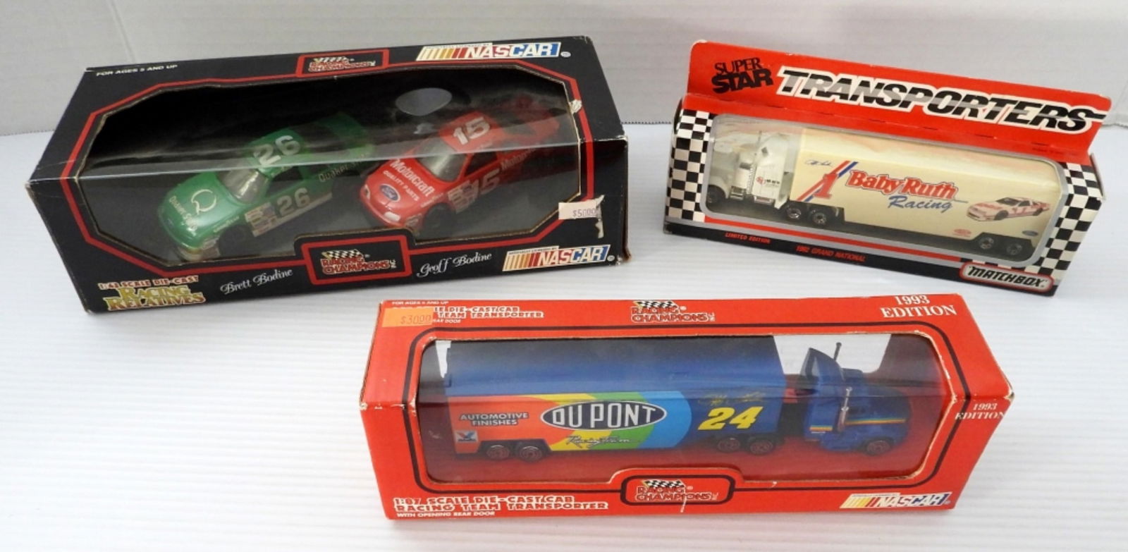 (3) RACING CHAMPIONS / MATCHBOX LOT: FACTORY SEALED BRAND NEW IN BOXES 1992-93 - RACING RELATIVES BRETT & GEOFF BODINE CARS, NASCAR 1:87 SCALE DIE-CAST CAB RACING TEAM TRANSPORTER, MATCHBOX 1992 GRAND NATIONAL LIMITED EDITION SUPER STAR