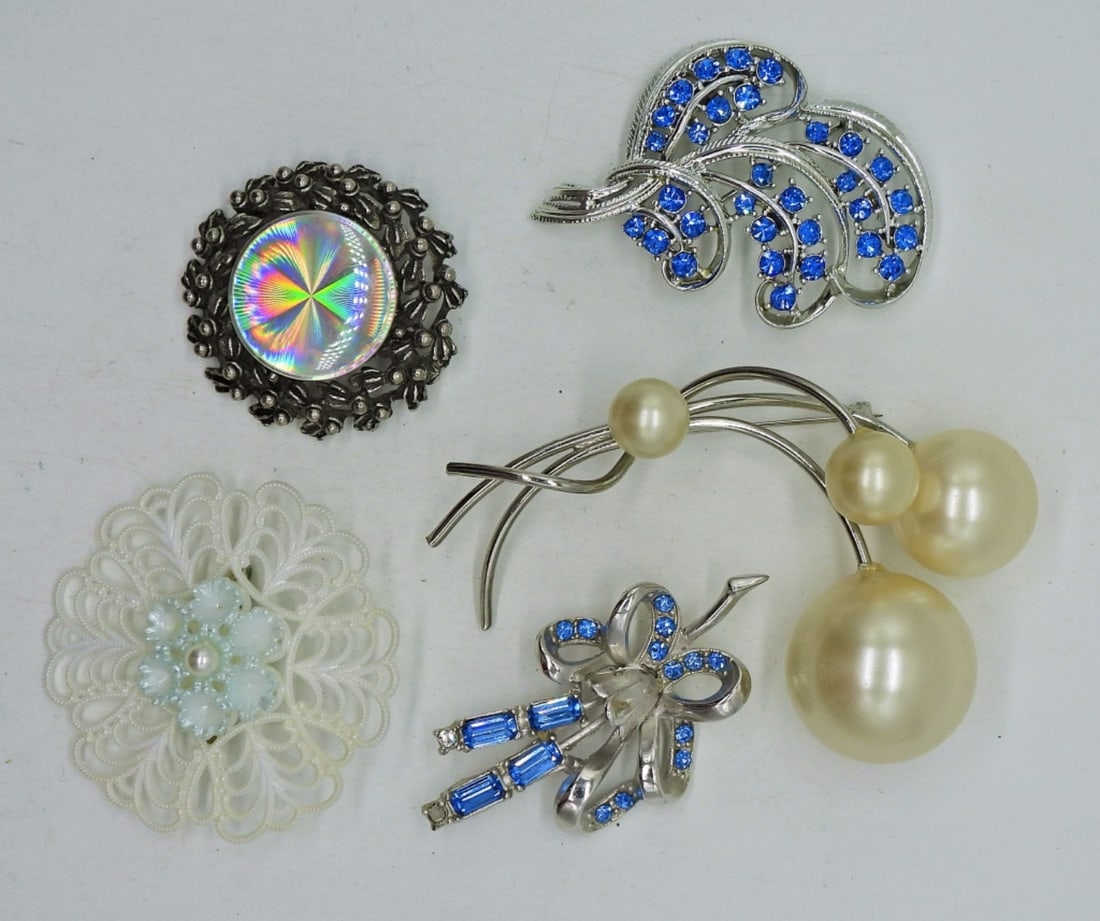 5 Vintage Brooches-Bakelite & More: Two Blue Gemstone and Silver Tone Vintage Brooches. Large Silver Tone Faux Pearl Brooch, 3.5"x2". Silver tone wreath style brooch (Broken, see Photos). White Bakelite Brooch with a faux pearl accent, 