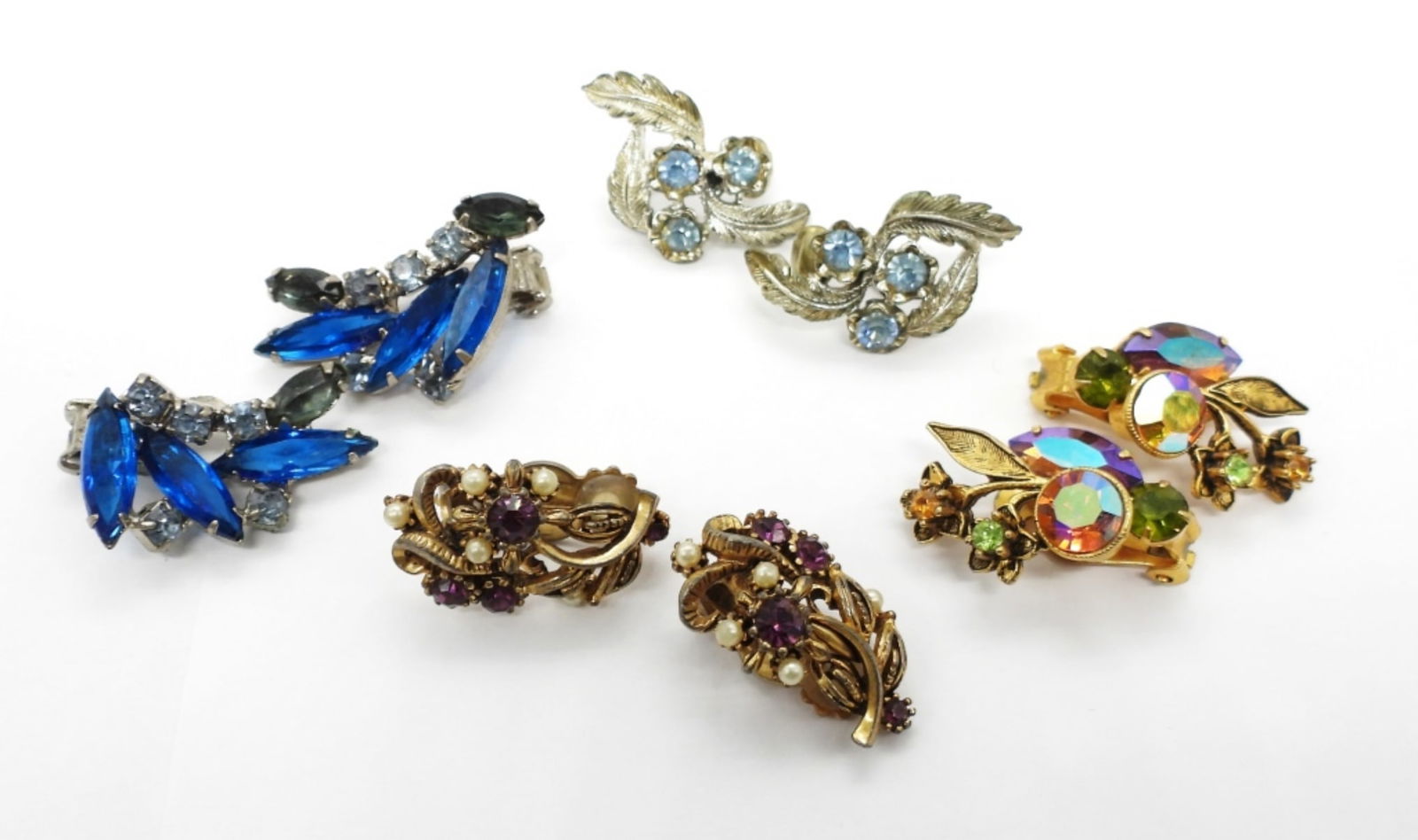 Vintage CORO Earrings & 3 More: Four Pair of Vintage Gold and Silver Tone Clip On Earrings. CORO Brand Silver Tone Earrings with Aquamarine Colored Rhinestones. Vintage Silver Tone with Dark and Light Blue Rhinestones. Two Pair of G