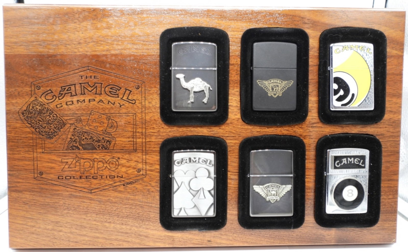 (6) THE CAMEL COMPANY ZIPPO COLLECTION PLAQUE: ALL FROM THE 90S, ALL SEALED, IN A WOODEN PLAQUE DISPLAY